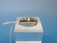 An 18ct gold ring set with five diamonds (size M)