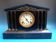 A black slate style mantel clock in Romanesque style by Ahsomia,
