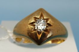 A Victorian 18ct gold ring set with a diamond in a star setting,