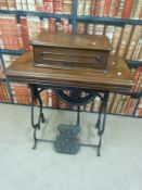 A 19thC mahogany cased treadle operated overlocker with Grover and Baker S.M. Co.