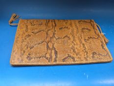 A snake skin document folder.