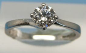 A platinum ring set with a round brilliant cut solitaire diamond of approximately 0.