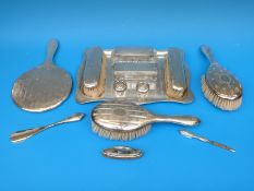 A hallmarked silver dressing table set on tray, comprising seven pieces and tray,