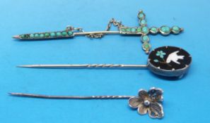 A stick pin marked 80 in the shape of a sword set with turquoise,