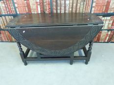 An antique oak drop leaf table with pegged joints,