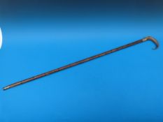 A Victorian walking stick with rattan shaft, rhinoceros horn handle,