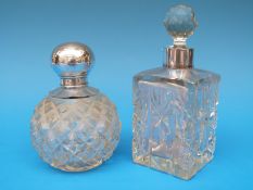 A hallmarked silver mounted globe shaped dressing table bottle and a white metal mounted square