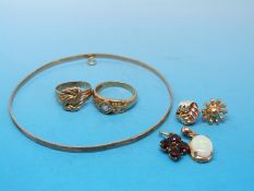 Two 9ct gold rings one set with clear stones and the other a knot design, a 9ct gold bangle,