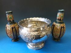 A large embossed silver plated bowl together with a pair of continental ceramic vases
