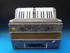 An eight bass Estrella piano accordion, in ivory pearloid finish,