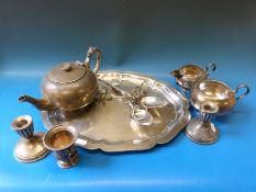 A pair of white metal candlesticks, marked to underside sterling weighted,