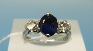 A platinum ring set with a oval cut sapphire of approximately 1.