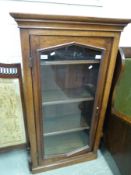 A mahogany glazed book or display case with adjustable shelves and panelled sides,