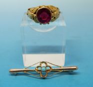 A gold ring set with a synthetic ruby (size Q), probably late 19th / 20thC but marks rubbed (4.