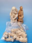 A collection of ivory/bone items to include a Chinese chess piece and a carving of a wise monkey