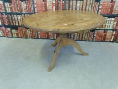 A circular pine kitchen table,
