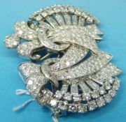 A platinum metamorphic brooch set with diamonds in two stylised bow shapes with fans of baguette
