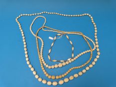 A collection of ivory necklaces to include two beaded examples,
