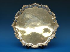 A hallmarked silver salver with shaped and moulded edge,