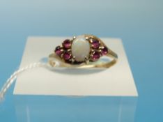 A 9ct gold ring set with an opal and rubies (size K)