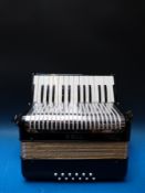 A Bell 12 bass piano accordion in black finish,