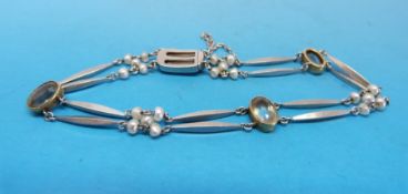An Edwardian platinum and gold bracelet set with aquamarines and seed pearls