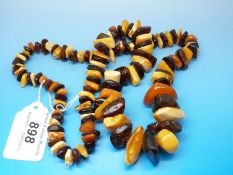 An amber necklace consisting of over 100 irregular pieces,