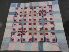 A patchwork quilt made first half of 20thC and decorated with a central design of red paisley