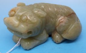 A Chinese jade model of a lion, finely carved with large russet inclusion to base (7.