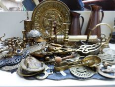 A collection of brass and copperware, including calendar, candlesticks,
