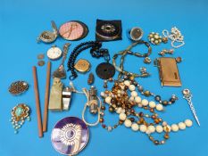 A collection of costume jewellery to include beads, compacts, whistle, compass,