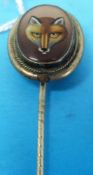 A 19thC stick pin set with a fox's head painted on glass with rope border