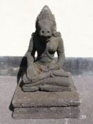 An Indonesian carved volcanic sculpture of a horse headed goddess raised on a carved plinth (height