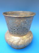 A Persian brass jardiniere with openwork flared rim and bands of calligraphy around the centre of