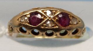 A yellow metal ring marked 18ct gold set with two rubies with alternating diamonds (size E)