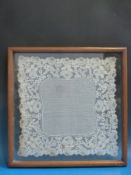 Two Victorian handmade lace doilies in glazed frames together with a framed sampler,