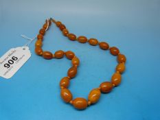 A Baltic amber necklace of butterscotch colour, the beads of oval form, largest bead 1.4cm (16.