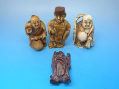 Four Japanese netsukes including an artist and Hotei