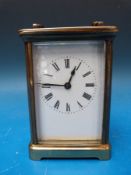 A brass carriage clock in Corniche style case, white enamelled dial,