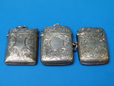 Three hallmarked silver vesta cases all with engraved floral decoration