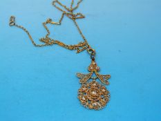 A with a gold filigree pendant set with natural pearls on a gold chain