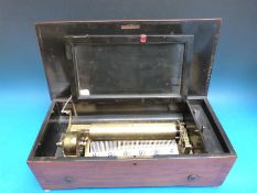 A cylinder music box playing eight airs on a brass bed plate, thought to be manufactured by Bremond.