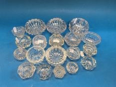 A collection of 19 pressed glass salts of various sizes
