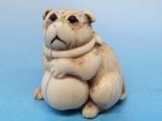 A 19thC Japanese netsuke of a pug and a ball
