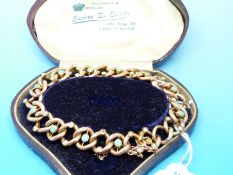 An Edwardian yellow metal bracelet of large links set with turquoise and seed pearls,