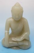 A pale celadon jade carving of a Buddha, intricately carved with serene expression (7.