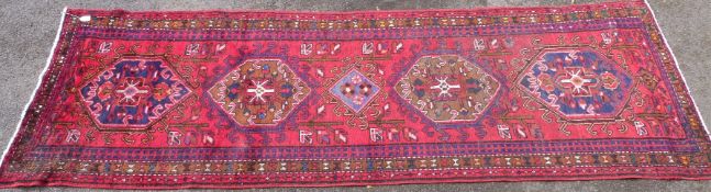 A Persian Heriz red ground runner (L298 x W96cm)