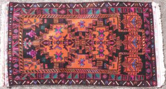 A hand-woven Afghan wool Baluch rug (L143 X W79cm)