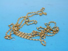 A yellow metal chain of decorative links