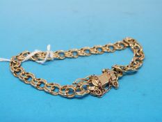 A yellow metal double link bracelet (10.